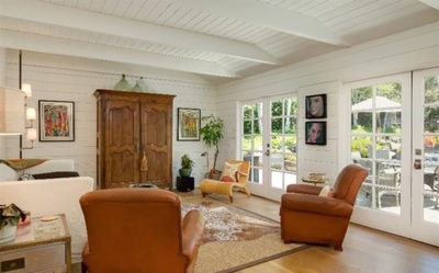 Traditional Farmhouse design family room with white shiplap and light medium hardwood flooring 
