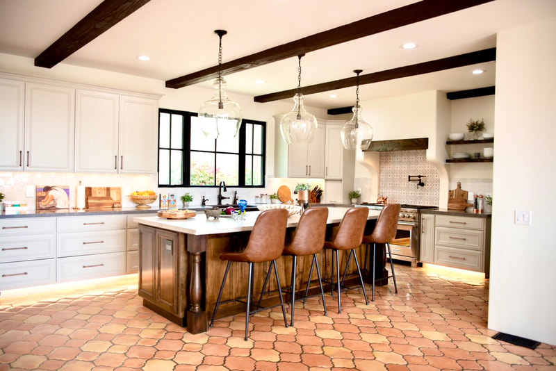 Spanish Revival design with Terra-cotta Satillo tile floors with large island and under cab lighting in Kitchen