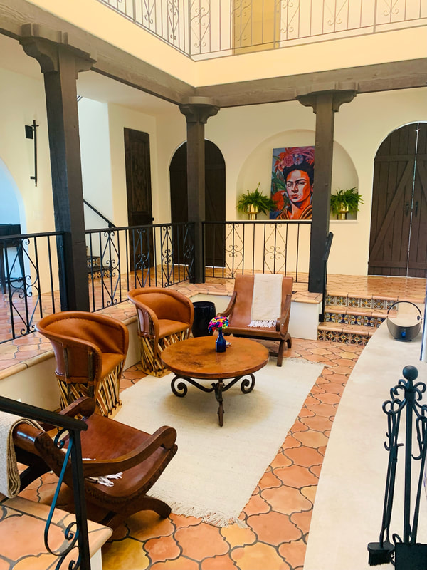 Spanish Revival design with terra-cotta  Saltillo tile and black wrought iron railing 